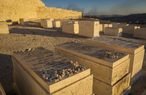 <p>Horizontal close-up view of some of the graves of the Mount of Olives Jewish Cemetery, with the smoke on Gaza Strip in the background, in Jerusalem</p>