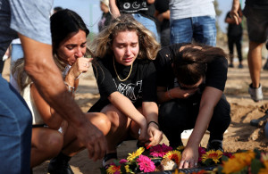 <p>People mourn at the graveside of Eden Guez during her funeral in Ashkelon, Israel, Oct. 10, 2023. She was killed during an Oct. 7 music festival that was attacked by Hamas gunmen from Gaza. Israel increased airstrikes on the Gaza Strip and sealed it off from food, fuel and other supplies Oct. 9 in retaliation for a bloody incursion by Hamas militants. (OSV News photo/Violeta Santos Moura, Reuters)</p>
