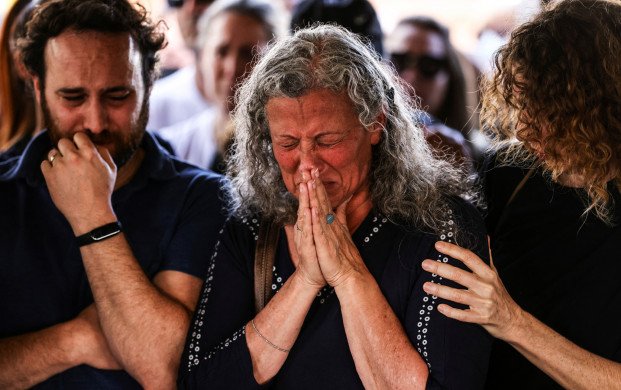 <p>Friends and family mourn at the funeral of Eytam Magini who was killed during a Tel Aviv bar attack by a Palestinian gunman, in Kfar Saba, Israel, April 10, 2022. REUTERS/Ronen Zvulun</p>