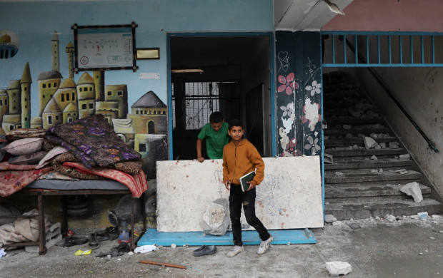 <p>Palestinians inspect the site of an Israeli strike on a UNRWA school sheltering displaced people, amid the Israel-Hamas conflict, in Nuseirat refugee camp in the central Gaza Strip, June 6, 2024. REUTERS/Abed Khaled</p>