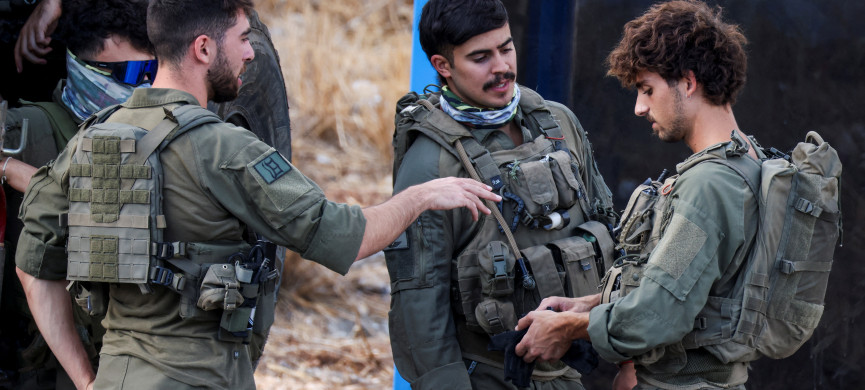 <p>Israeli soldiers ready their kit, amid cross-border hostilities between Hezbollah and Israel, in northern Israel October 1, 2024. REUTERS/Jim Urquhart</p>