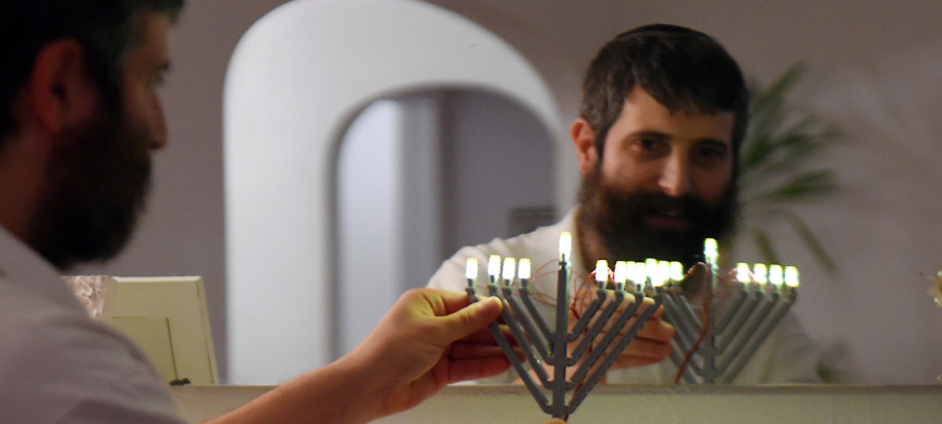 <p>Yitzy Kasowitz places one his Lego Menorahs on the fireplace mantel at his Highland Park home in St. Paul on Wednesday, Dec. 2, 2015. Kasowitz's business, JBlock, produces Jewish-themed Lego sets. (Pioneer Press: John Autey)</p>