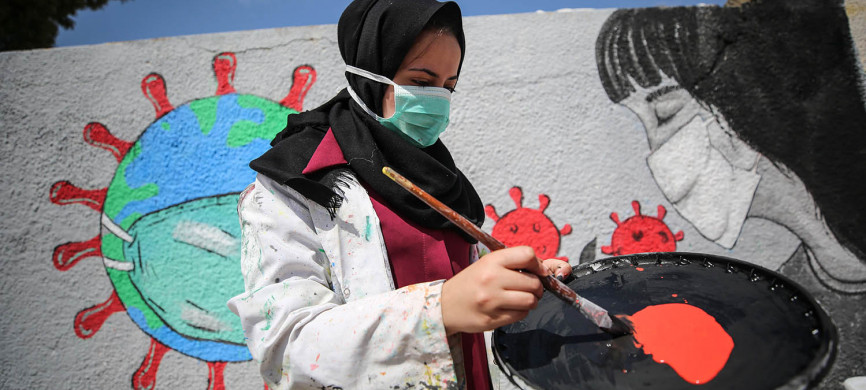 <p>Palestinian painters work on a mural to draw attention to the novel coronavirus pandemic in Khan Yunis, Gaza, on March 28. Mustafa Hassona/Anadolu Agency via Getty Images</p>