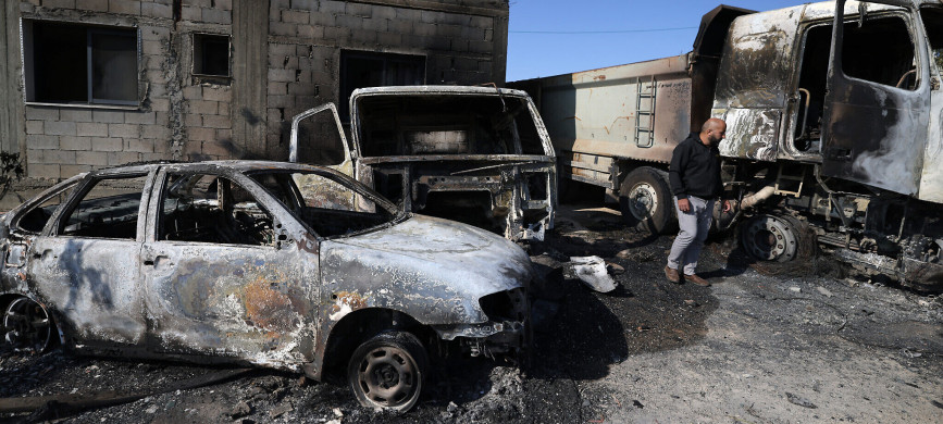 <p>A Palestinian inspects the damage to vehicles in the village of Mughayir near Ramallah in the Israeli-occupied West Bank on April 13, 2024, set ablaze by Israeli settlers during an attack on the village. (Photo by JAAFAR ASHTIYEH / AFP)</p>
